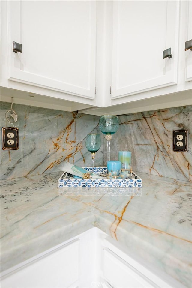 20 Nuevo Unit 10, Irvine, CA 92612 - kitchen view of decorative backsplash, white cabinets, and light stone counters