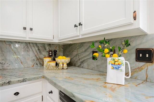 20 Nuevo Unit 10, Irvine, CA 92612 - kitchen view of white cabinets, decorative backsplash, and light stone counters