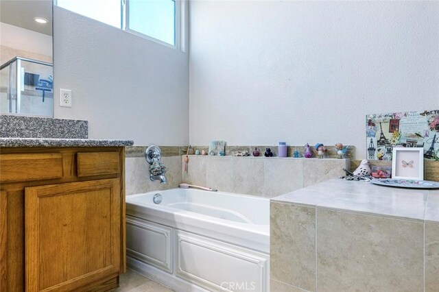 6 N Post Ave, Sanger, CA 93657 - full bathroom featuring a garden tub, a shower stall, vanity, and a textured wall