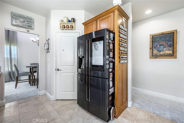 6 N Post Ave, Sanger, CA 93657 - kitchen featuring black fridge with ice dispenser, light carpet, brown cabinets, and recessed lighting
