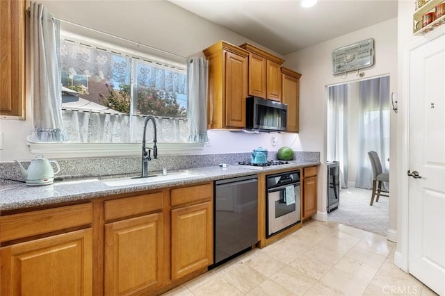 6 N Post Ave, Sanger, CA 93657 - kitchen featuring stainless steel appliances, brown cabinets, light stone countertops, light carpet, and light tile patterned flooring