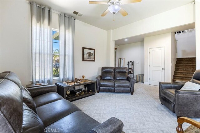 6 N Post Ave, Sanger, CA 93657 - living room with light colored carpet, a ceiling fan, and stairs