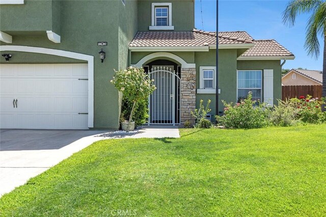6 N Post Ave, Sanger, CA 93657 - view of front facade with stucco siding, a tile roof, stone siding, and concrete driveway