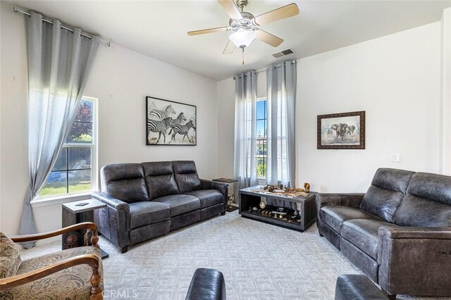 6 N Post Ave, Sanger, CA 93657 - living area featuring healthy amount of natural light, a ceiling fan, and carpet flooring