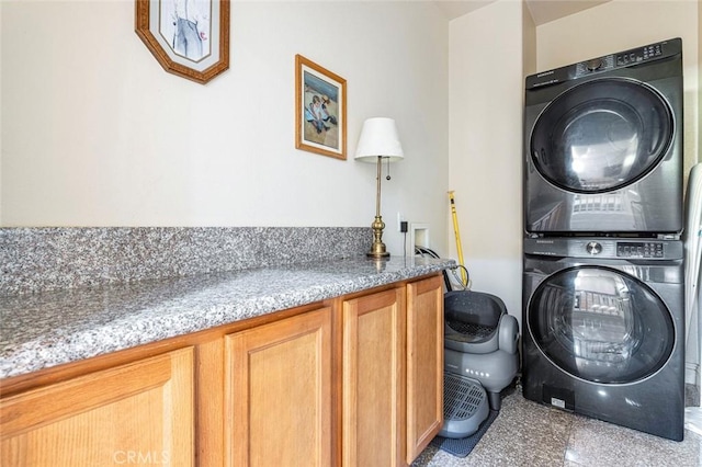 6 N Post Ave, Sanger, CA 93657 - laundry room featuring stacked washer and clothes dryer, cabinet space, and granite tiled floors