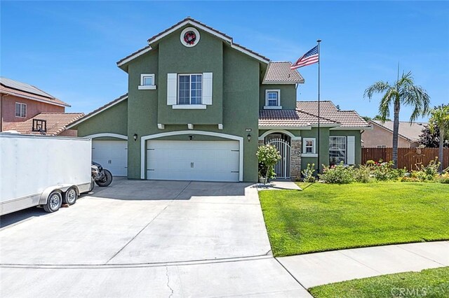 6 N Post Ave, Sanger, CA 93657 - mediterranean / spanish house featuring stucco siding, a tiled roof, driveway, and an attached garage