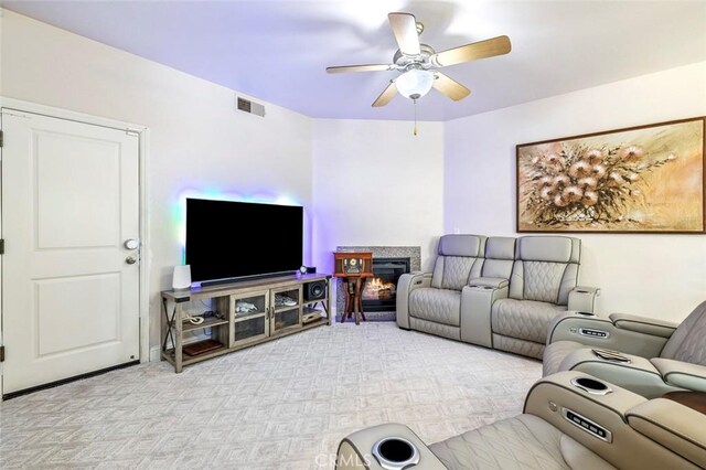 6 N Post Ave, Sanger, CA 93657 - living room featuring a ceiling fan, a glass covered fireplace, and light colored carpet