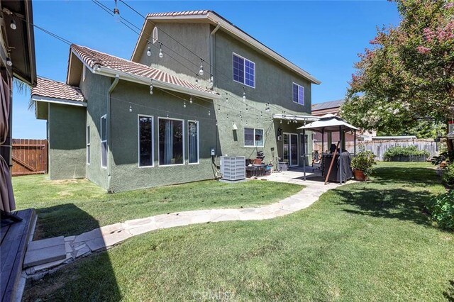 6 N Post Ave, Sanger, CA 93657 - rear view of property featuring stucco siding, a patio, a tiled roof, and a gazebo
