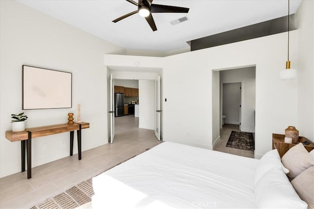 42407 Liolios Dr, Palm Desert, CA 92211 - bedroom with light tile patterned floors, freestanding refrigerator, vaulted ceiling, and ceiling fan
