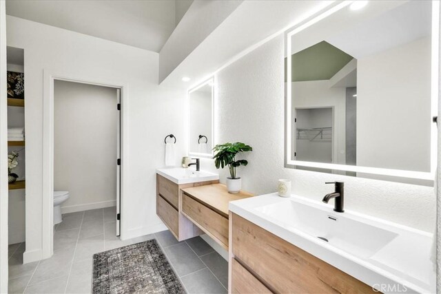 42407 Liolios Dr, Palm Desert, CA 92211 - full bathroom with two vanities, tile patterned flooring, and a closet