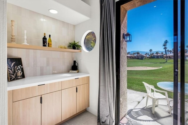 42407 Liolios Dr, Palm Desert, CA 92211 - indoor dry bar featuring backsplash and light tile patterned flooring