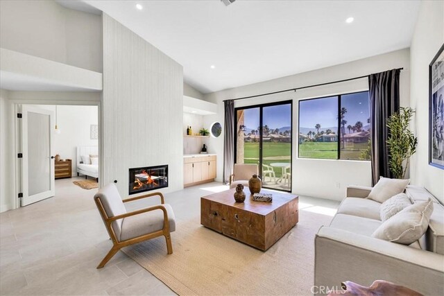 42407 Liolios Dr, Palm Desert, CA 92211 - living area featuring a large fireplace, high vaulted ceiling, and recessed lighting