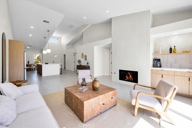 42407 Liolios Dr, Palm Desert, CA 92211 - living area featuring high vaulted ceiling, a large fireplace, and recessed lighting