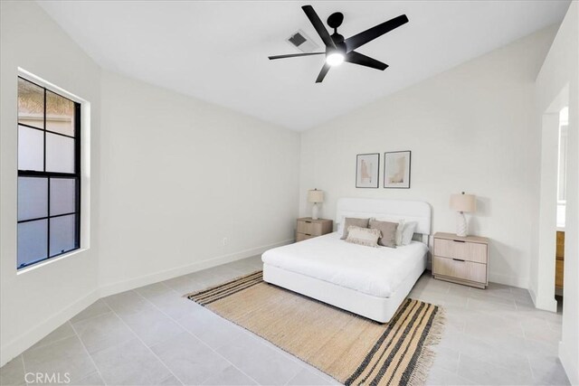 42407 Liolios Dr, Palm Desert, CA 92211 - bedroom featuring vaulted ceiling, tile patterned floors, and a ceiling fan
