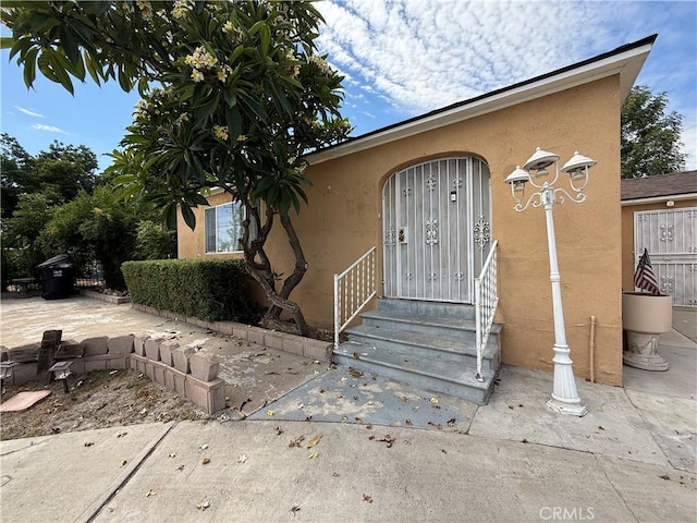 1246 W Mill St, San Bernardino, CA 92410 - doorway to property with stucco siding
