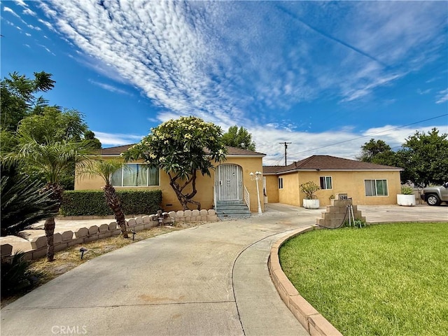 1246 W Mill St, San Bernardino, CA 92410 - view of front of home with stucco siding and a front yard
