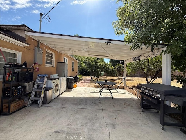 1246 W Mill St, San Bernardino, CA 92410 - view of patio / terrace with separate washer and dryer, outdoor dining space, and a grill