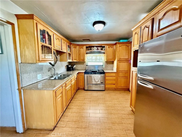1246 W Mill St, San Bernardino, CA 92410 - kitchen with appliances with stainless steel finishes, glass insert cabinets, backsplash, under cabinet range hood, and light wood-style flooring