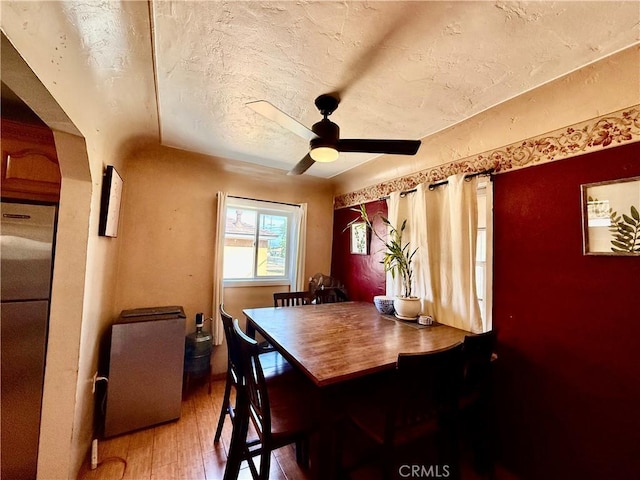 1246 W Mill St, San Bernardino, CA 92410 - dining space featuring light wood finished floors, ceiling fan, and a textured ceiling