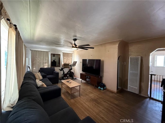 1246 W Mill St, San Bernardino, CA 92410 - living room with a heating unit, wood finished floors, ceiling fan, and arched walkways