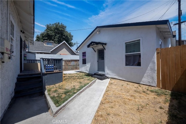 147114711/2 E 41st Pl, Los Angeles, CA 90011 - view of front facade with stucco siding and a deck