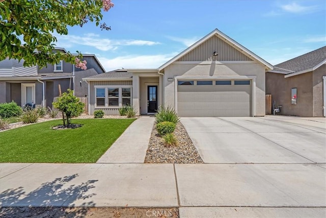 2454 W Mallard Ln, Hanford, CA 93230 - view of front facade featuring an attached garage, a front yard, driveway, and stucco siding
