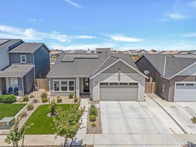 2454 W Mallard Ln, Hanford, CA 93230 - traditional-style house featuring an attached garage, driveway, solar panels, and a residential view