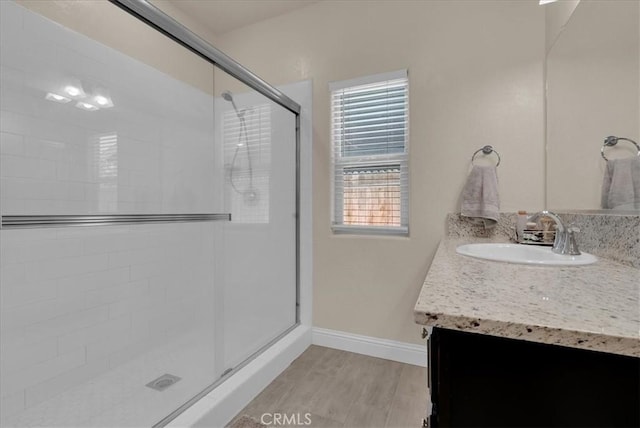 2454 W Mallard Ln, Hanford, CA 93230 - full bathroom with a stall shower, vanity, and wood finished floors