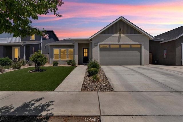 2454 W Mallard Ln, Hanford, CA 93230 - view of front facade featuring a garage, a yard, driveway, and stucco siding