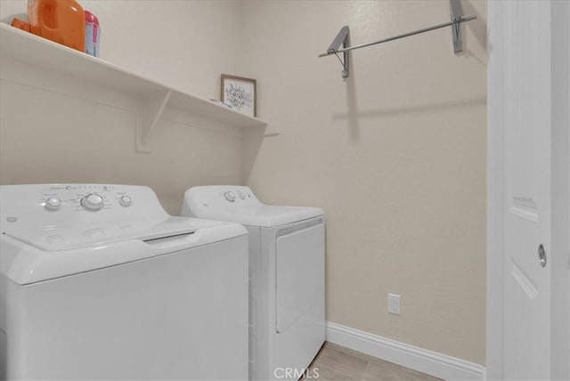 2454 W Mallard Ln, Hanford, CA 93230 - laundry room featuring washing machine and clothes dryer and baseboards