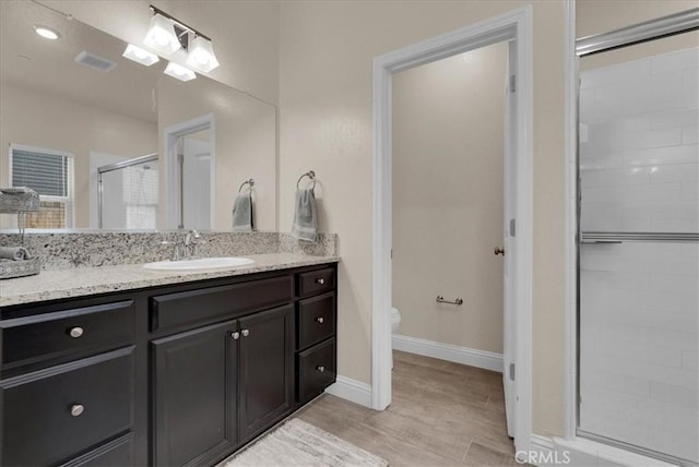 2454 W Mallard Ln, Hanford, CA 93230 - bathroom featuring a stall shower, vanity, and wood finished floors