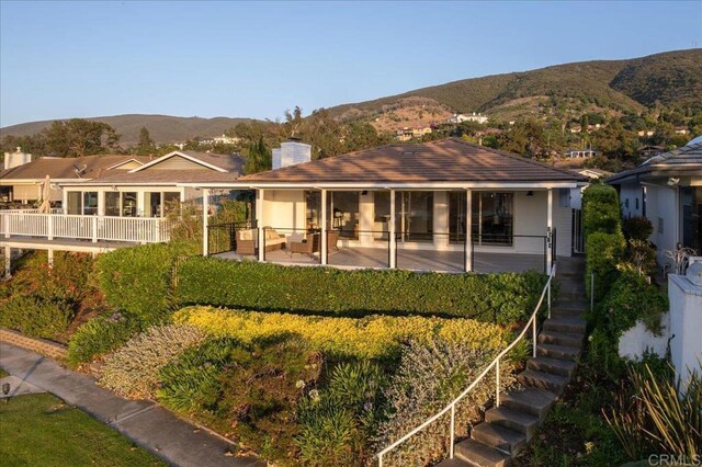 1515 San Pablo Dr, San Marcos, CA 92078 - rear view of property featuring a mountain view, a chimney, stairs, and a patio area