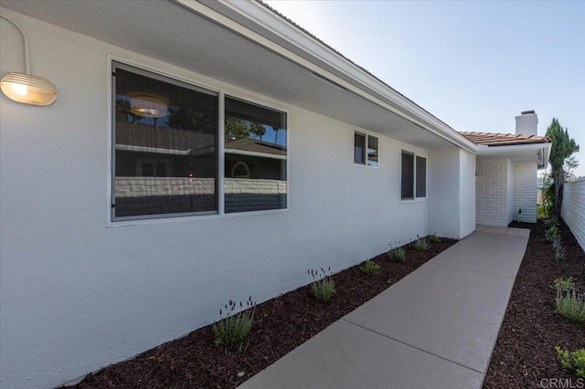 1515 San Pablo Dr, San Marcos, CA 92078 - view of side of property featuring a chimney, stucco siding, and a tiled roof