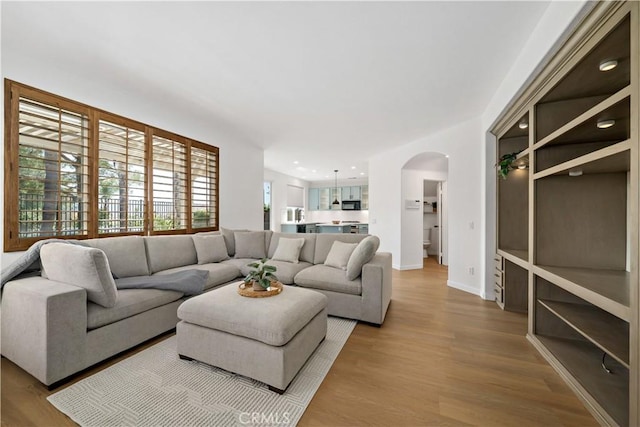 33307 Decada St, Temecula, CA 92592 - living area featuring arched walkways and wood finished floors