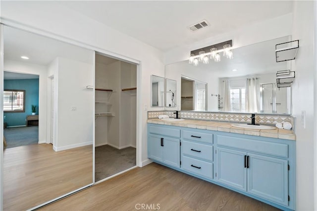 33307 Decada St, Temecula, CA 92592 - full bathroom featuring wood finished floors, tasteful backsplash, double vanity, plenty of natural light, and recessed lighting