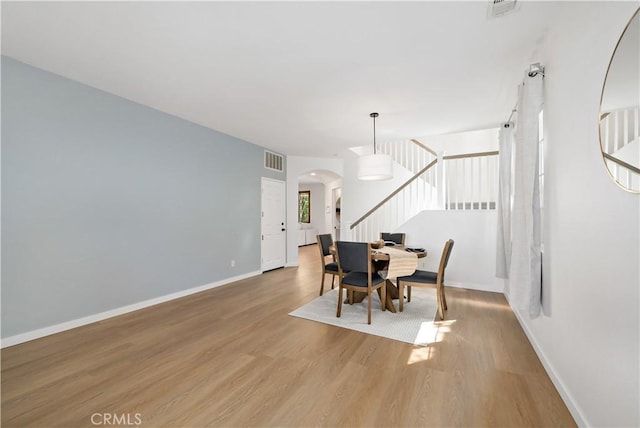 33307 Decada St, Temecula, CA 92592 - dining area featuring stairway, arched walkways, and wood finished floors