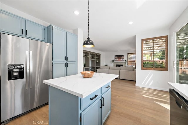 33307 Decada St, Temecula, CA 92592 - kitchen with stainless steel refrigerator with ice dispenser, blue cabinetry, plenty of natural light, and recessed lighting