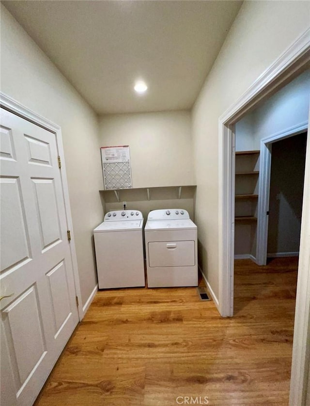1290 Tuck Rd, Willits, CA 95490 - washroom featuring washing machine and clothes dryer, light wood-style floors, and recessed lighting