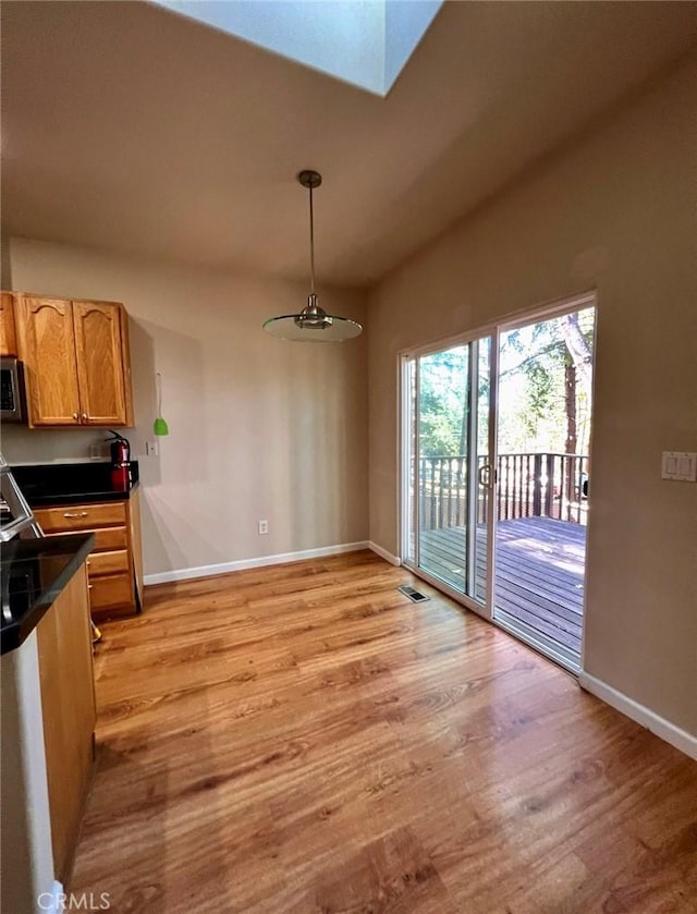 1290 Tuck Rd, Willits, CA 95490 - unfurnished dining area with light wood-type flooring and a skylight