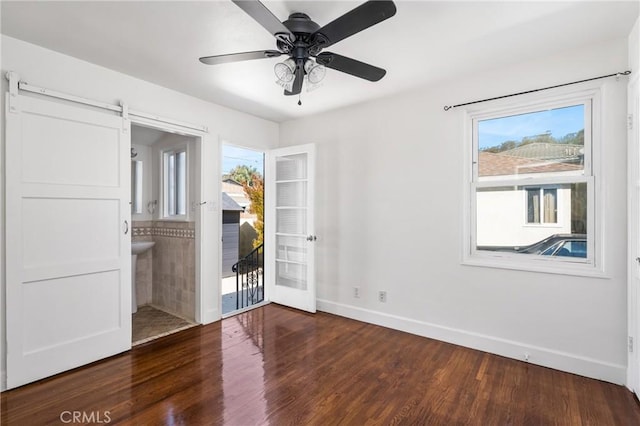 4851 Faculty Ave, Long Beach, CA 90808 - unfurnished room featuring wood finished floors, a barn door, and ceiling fan