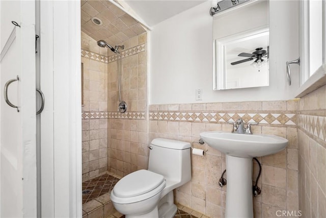 4851 Faculty Ave, Long Beach, CA 90808 - full bath with a shower stall, a wainscoted wall, a ceiling fan, and tile walls