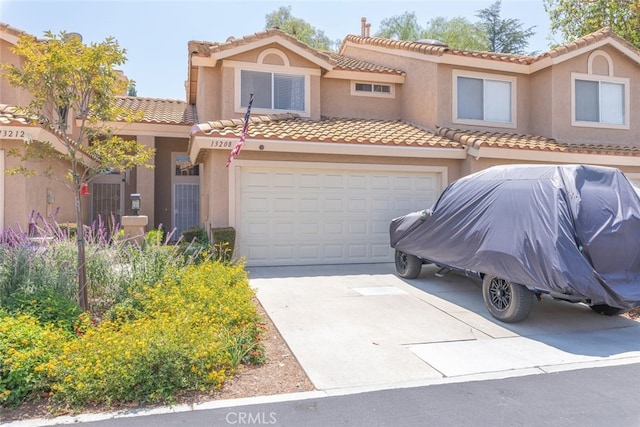13208 Setting Sun Ct, Chino Hills, CA 91709 - view of front facade with an attached garage, driveway, stucco siding, and a tiled roof