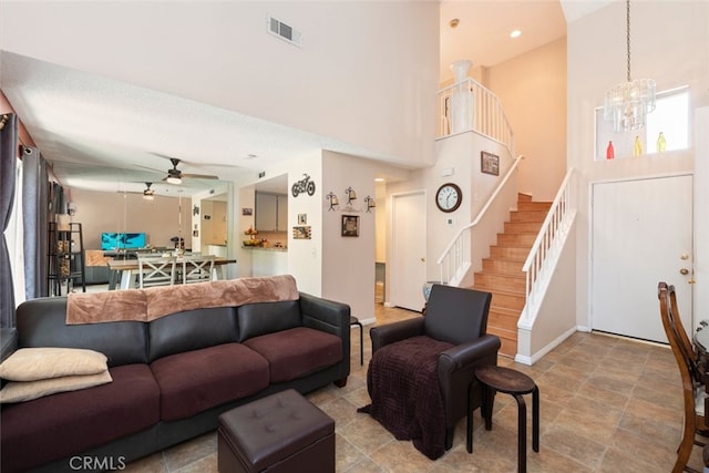 13208 Setting Sun Ct, Chino Hills, CA 91709 - living room with ceiling fan, stairway, a chandelier, a towering ceiling, and stone finish floors