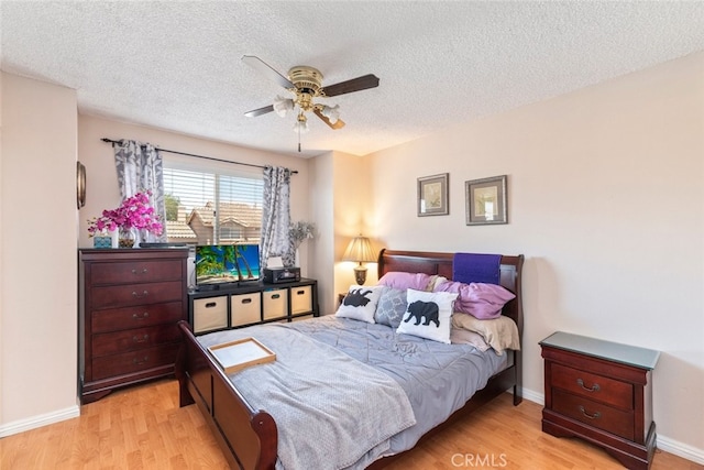 13208 Setting Sun Ct, Chino Hills, CA 91709 - bedroom with light wood-style flooring, a textured ceiling, and a ceiling fan