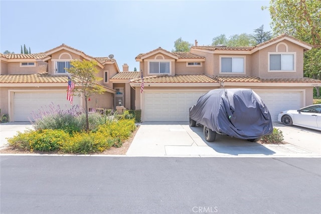 13208 Setting Sun Ct, Chino Hills, CA 91709 - townhome / multi-family property with an attached garage, stucco siding, driveway, and a tile roof