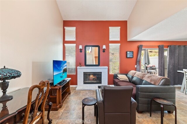 13208 Setting Sun Ct, Chino Hills, CA 91709 - living area with a brick fireplace, stone finish flooring, and vaulted ceiling