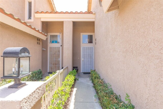 13208 Setting Sun Ct, Chino Hills, CA 91709 - view of exterior entry with stucco siding and a tile roof