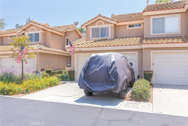 13208 Setting Sun Ct, Chino Hills, CA 91709 - townhome / multi-family property featuring driveway, stucco siding, a tiled roof, and an attached garage