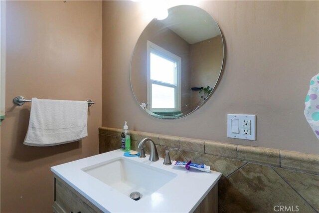 4981 Tulsa Ave, Riverside, CA 92505 - bathroom with vanity, wainscoting, and tile walls