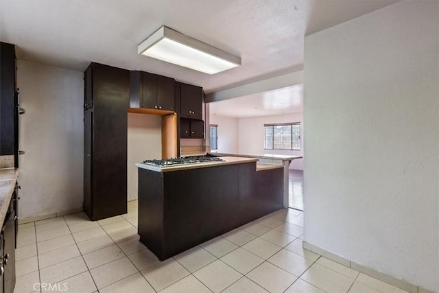 347 E 97th St, Los Angeles, CA 90003 - kitchen featuring light countertops, stainless steel gas stovetop, and light tile patterned floors